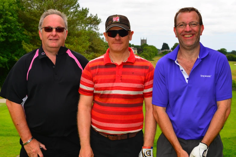 three men with sunglasses are standing beside one another