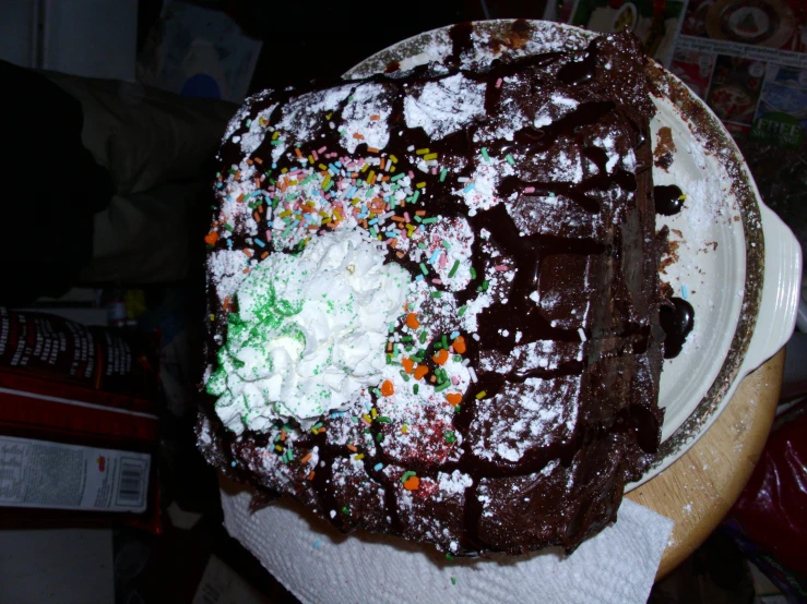 a giant piece of cake covered in various kinds of toppings