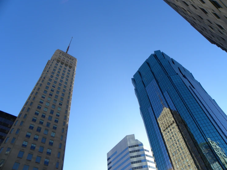 skyscrs stand beneath a blue sky in the city