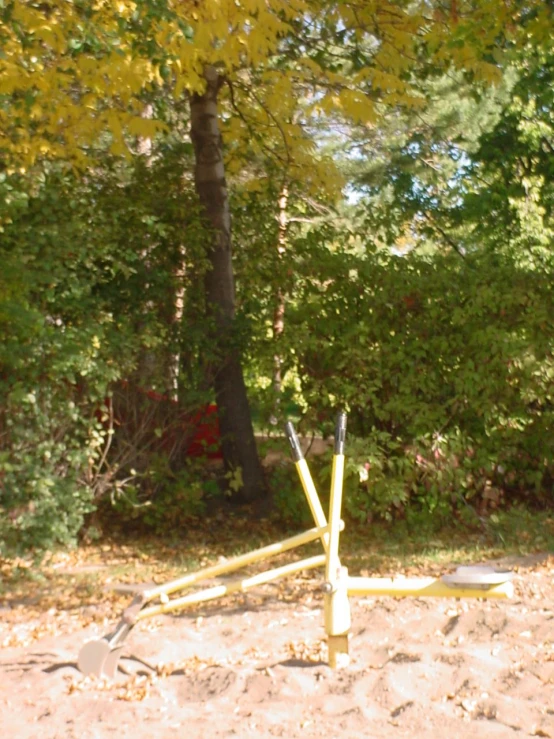 a couple of large yellow poles sitting in the middle of a field