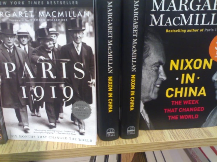 three books on a shelf at a bookstore