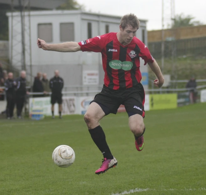 a young man is kicking a soccer ball around