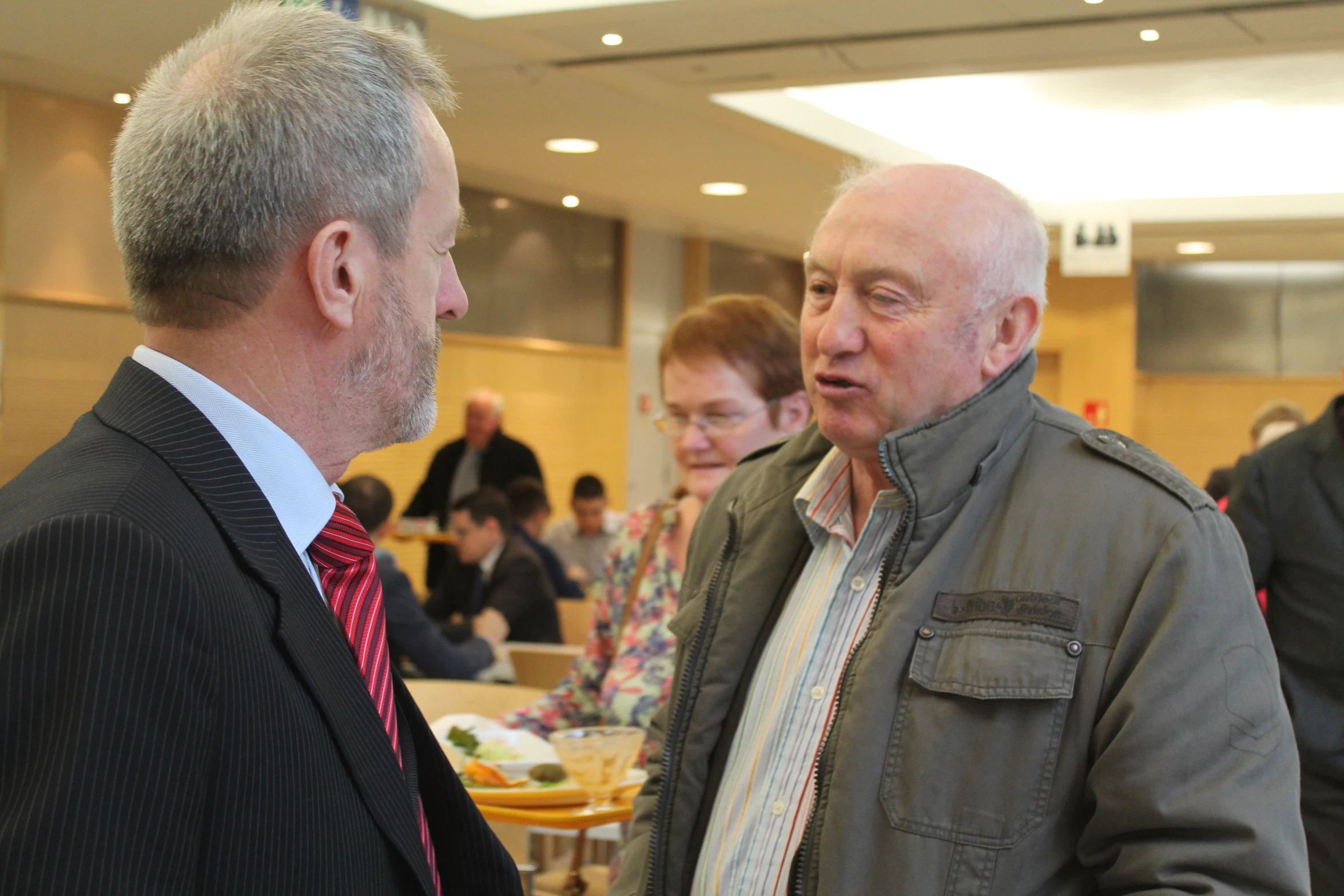 two men in suits talking to each other