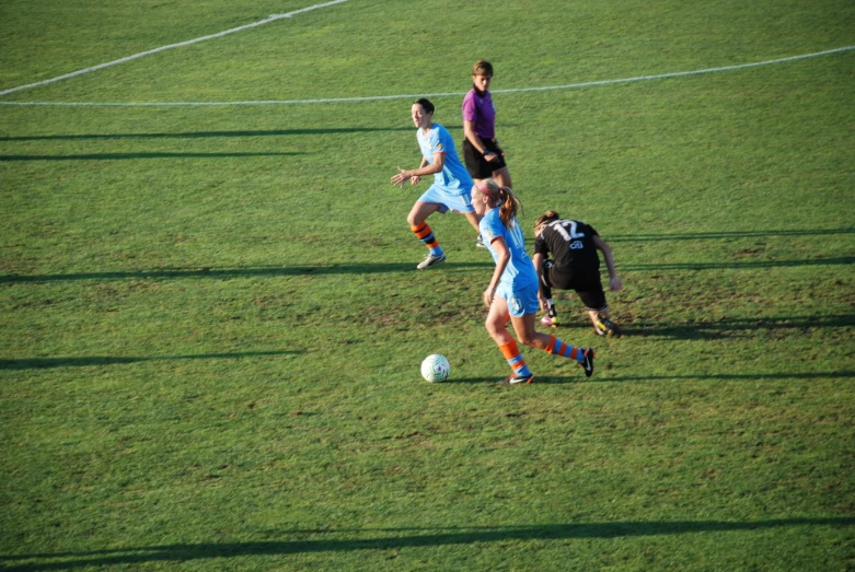 the soccer teams are on the field playing