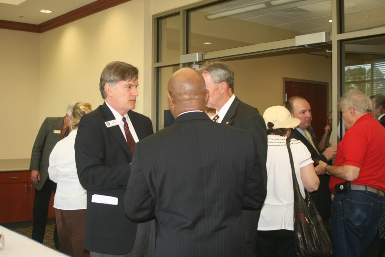 a group of people standing around in a room