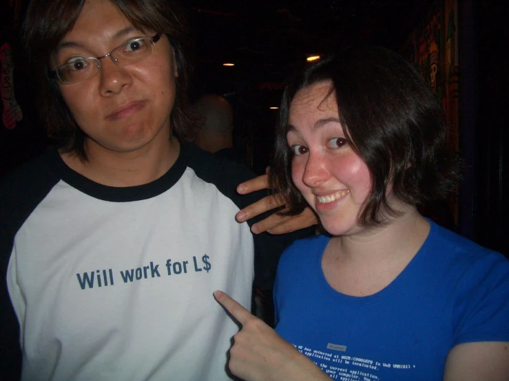 two people who are standing together in a dark room