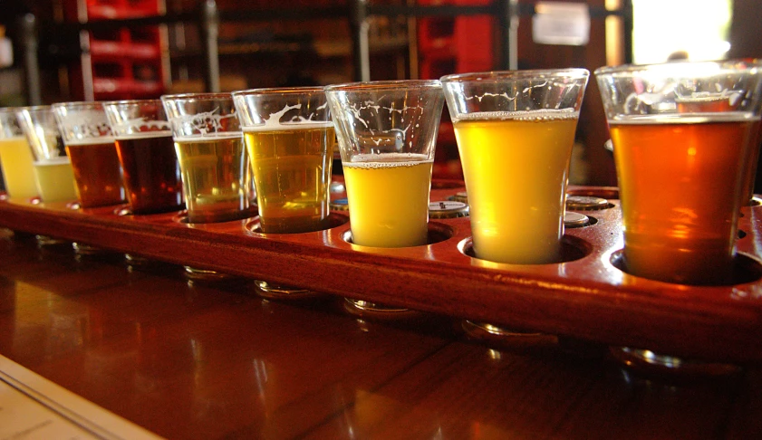 several different types of beer are lined up