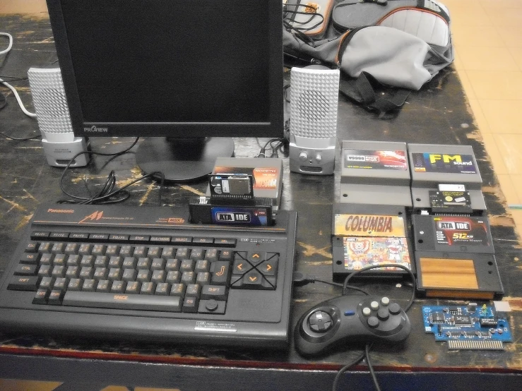 a computer and gaming equipment on the floor
