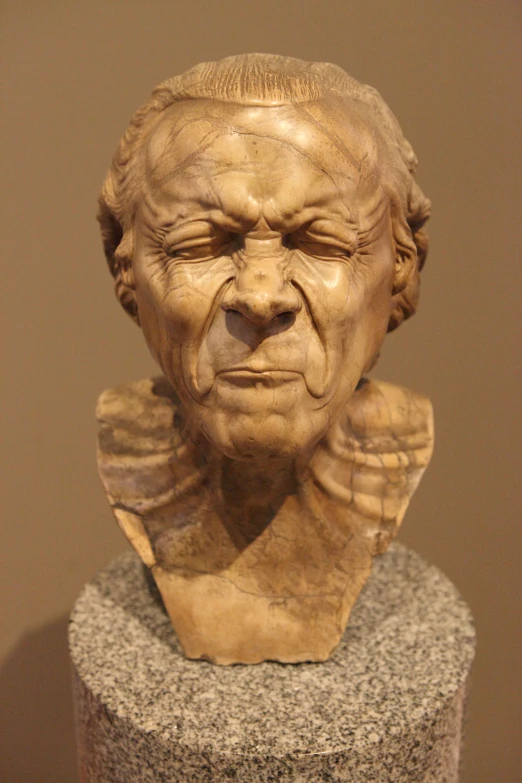 an old woman sculpture is placed in a museum