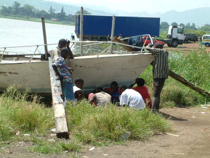 people are by the water near a boat