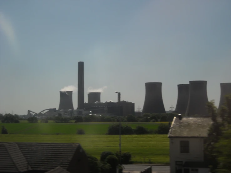 the factory is producing air pollution, while the grass is green