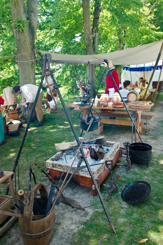 a group of people are sitting around near some picnic tables