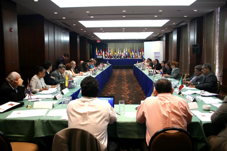 an asian board room with several people seated at the tables