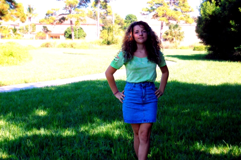 a pretty girl in short shorts standing on the grass