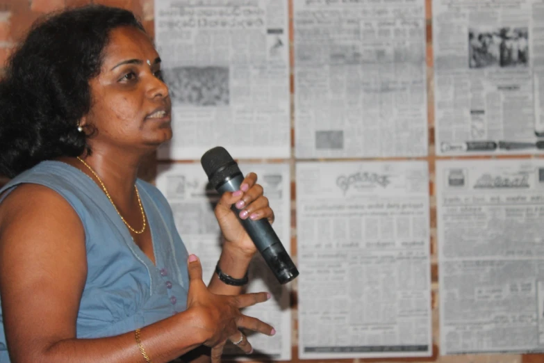 a woman standing up giving a presentation