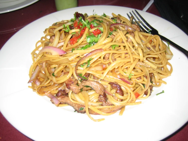 a white plate topped with pasta and vegetables