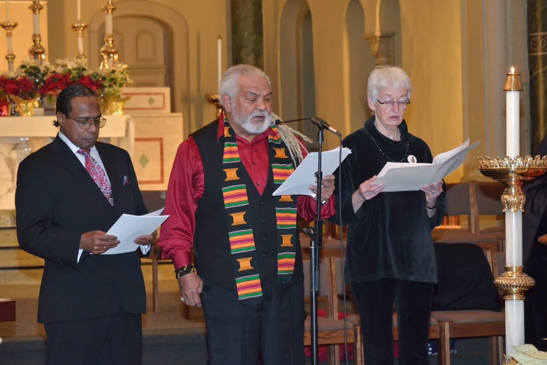 several people in church standing together at a ceremony