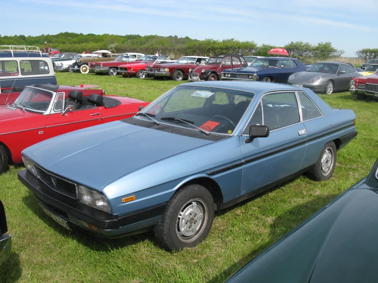 a number of cars in a field near one another