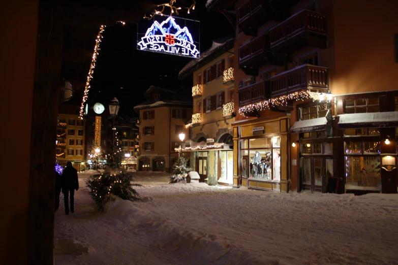 a large lite up christmas sign in the snow