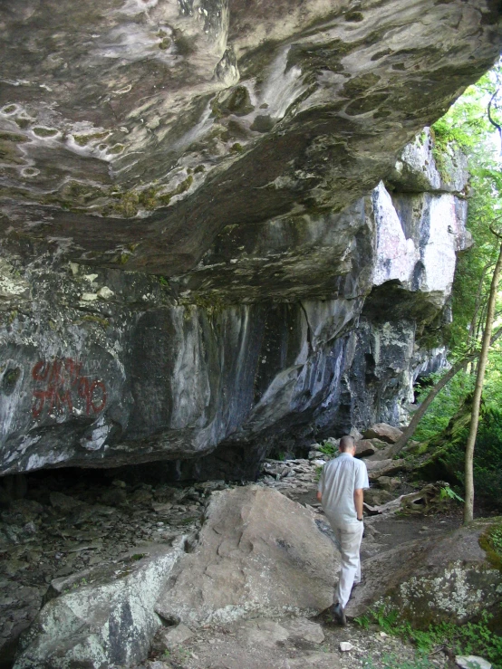 a man standing in front of a cliff