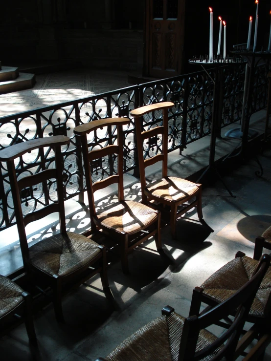 an outdoor area with a metal rail and chairs