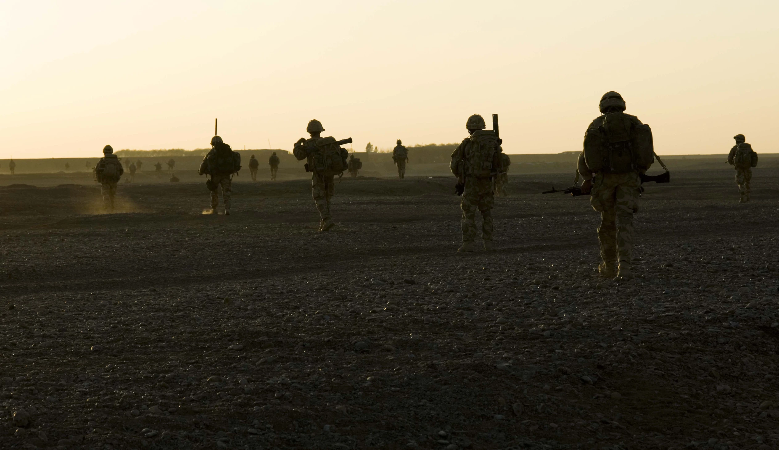 military in camouflage walking toward an enemy