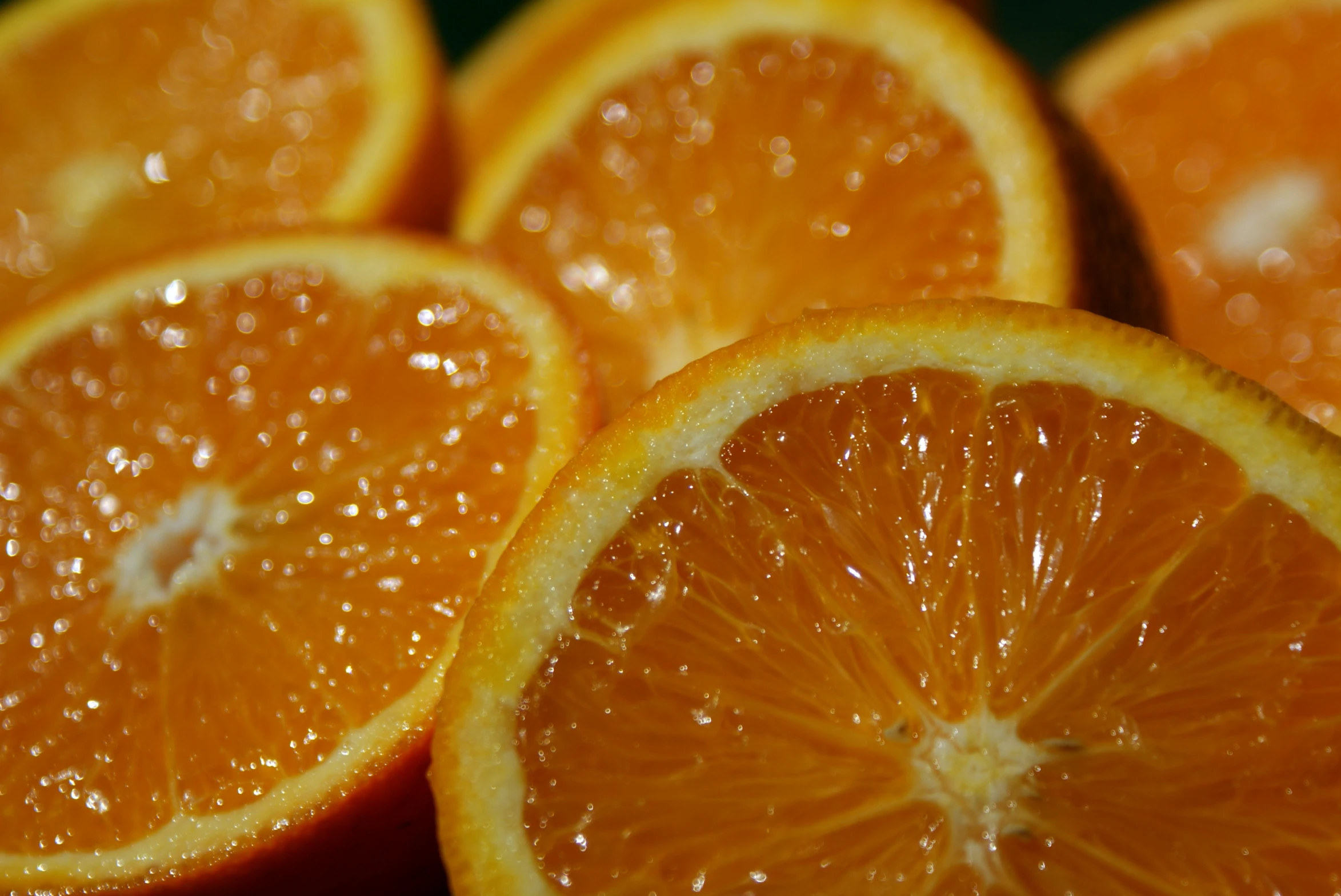 an orange and its halves with many drops on them