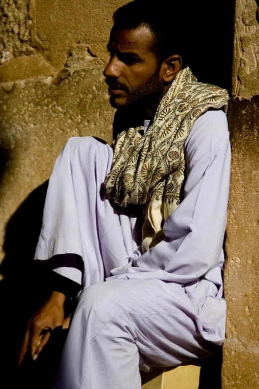a black man with beard wearing a scarf