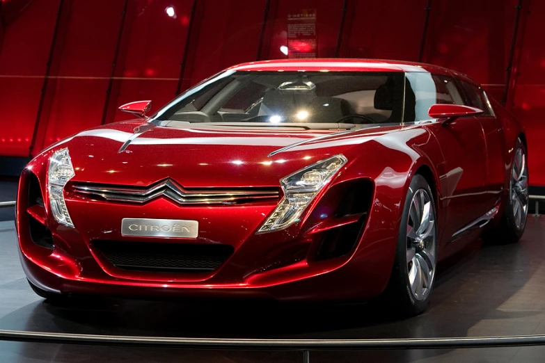 a very pretty red, sleek looking car on display