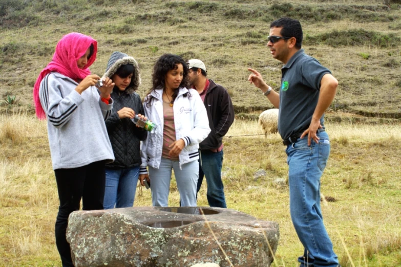 a group of people talking to one another