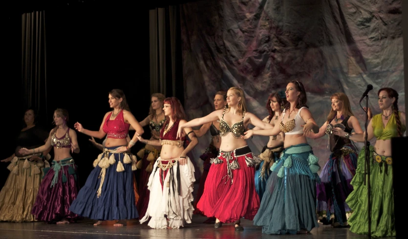 a group of women standing on top of a stage