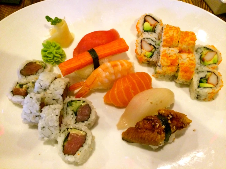 a plate of sushi, rice and carrots