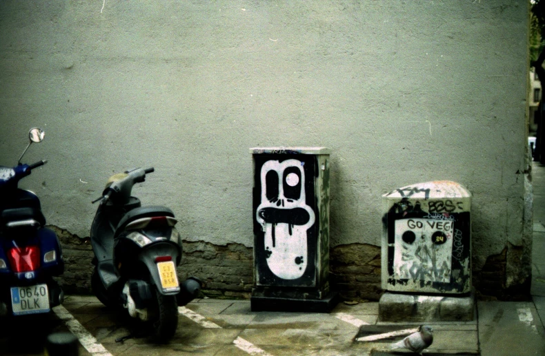 an abstractly painted po of a motor bike and scooter