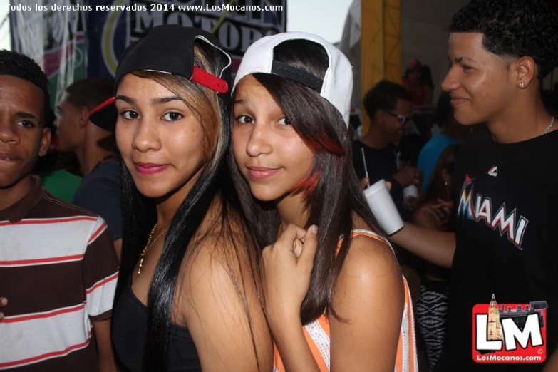 two young people posing for the camera while at a club