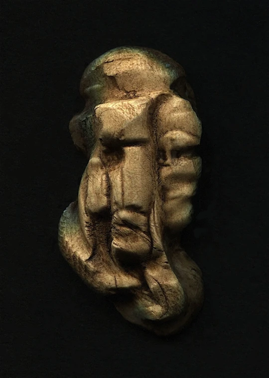 a sculpture of a face and the side view