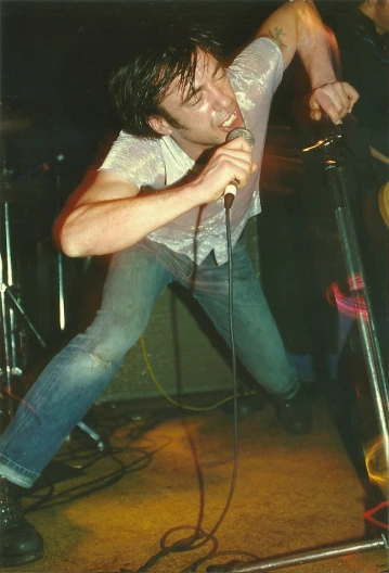 a male with a microphone on a stage