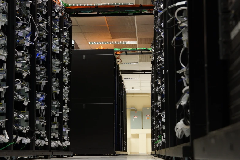 rows of black servers in the server room of a data center