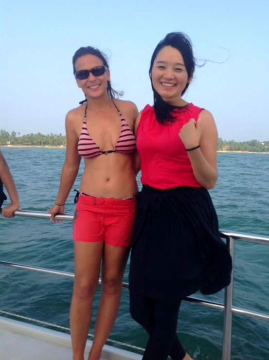 two girls in bikinis are on a boat