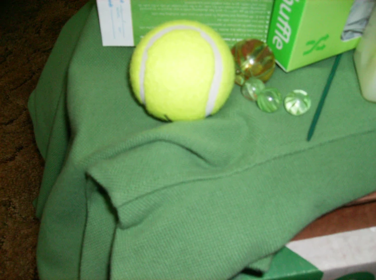 there is a tennis ball and other items on the ground
