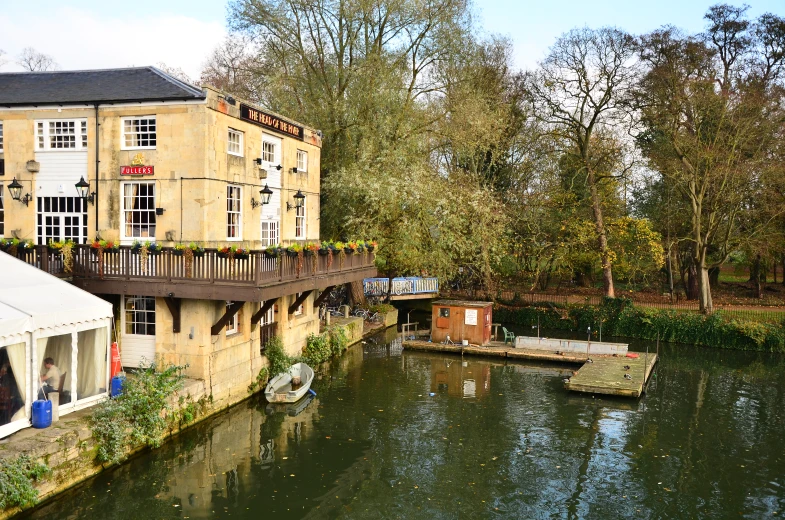 an image of people sitting on a porch near the river