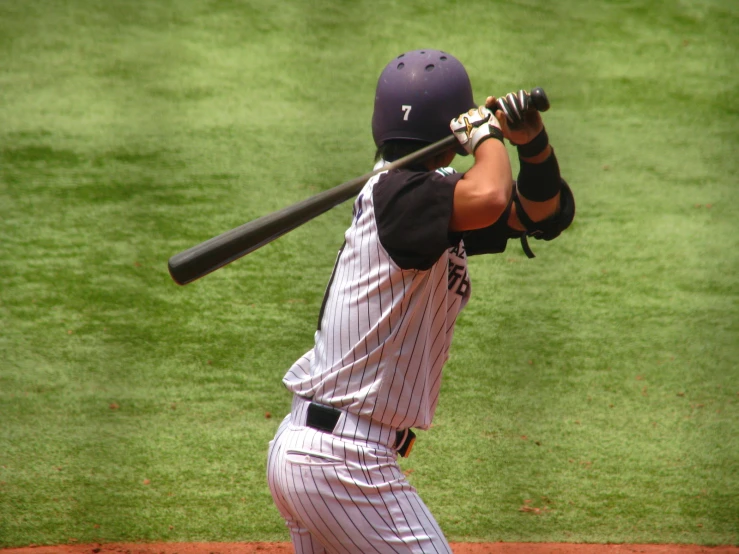 a man holding a bat with his arms in the air