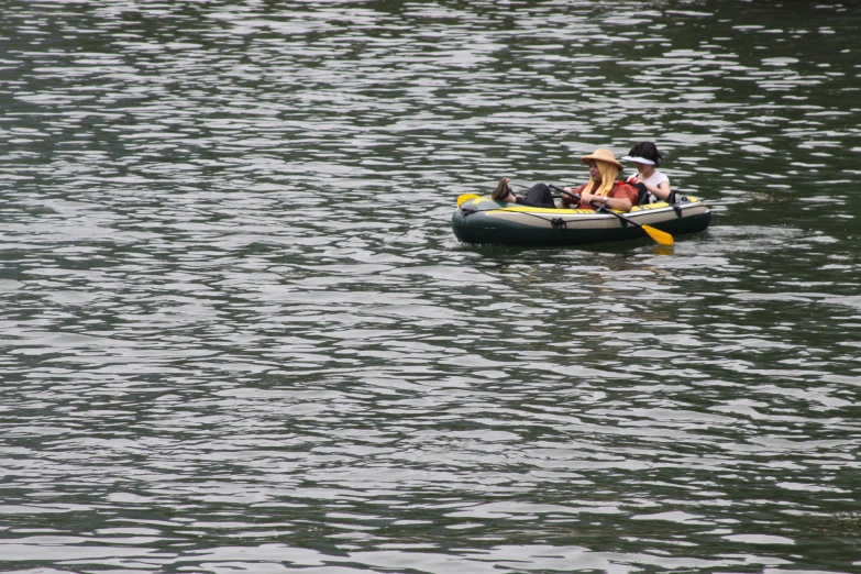 a group of people riding in a boat across a lake