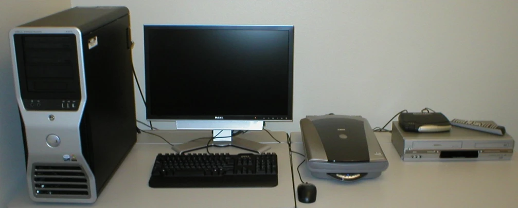 a desk with a desktop computer on top of it