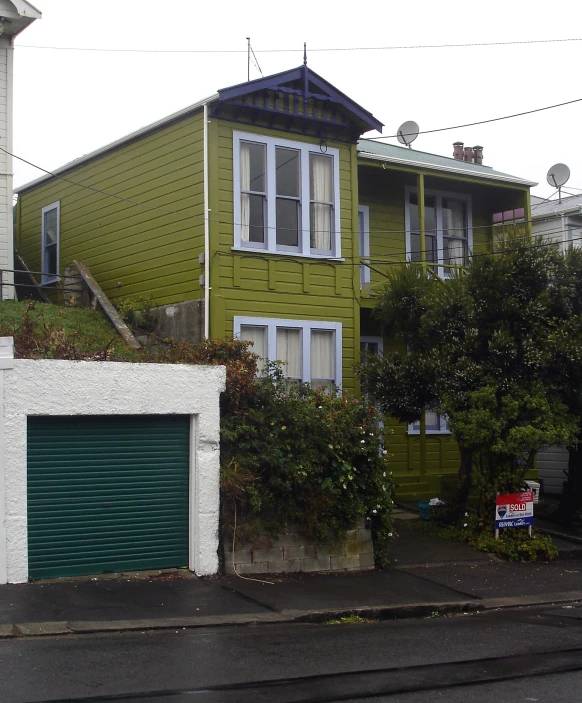 a house sits in the front yard of a hill