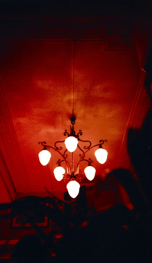 the room is very bright and red with chandelier