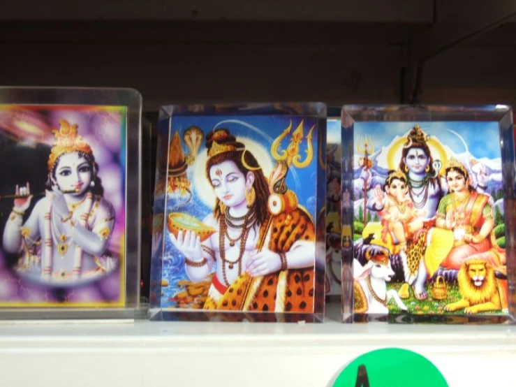 a collection of hindu cards displayed on top of a shelf