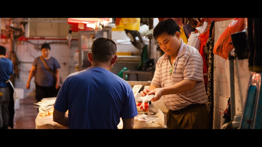 a man and another man making food inside of a kitchen