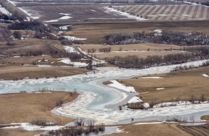 an aerial view of some snow and water in the country