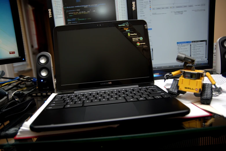 a laptop and speakers that are on a desk