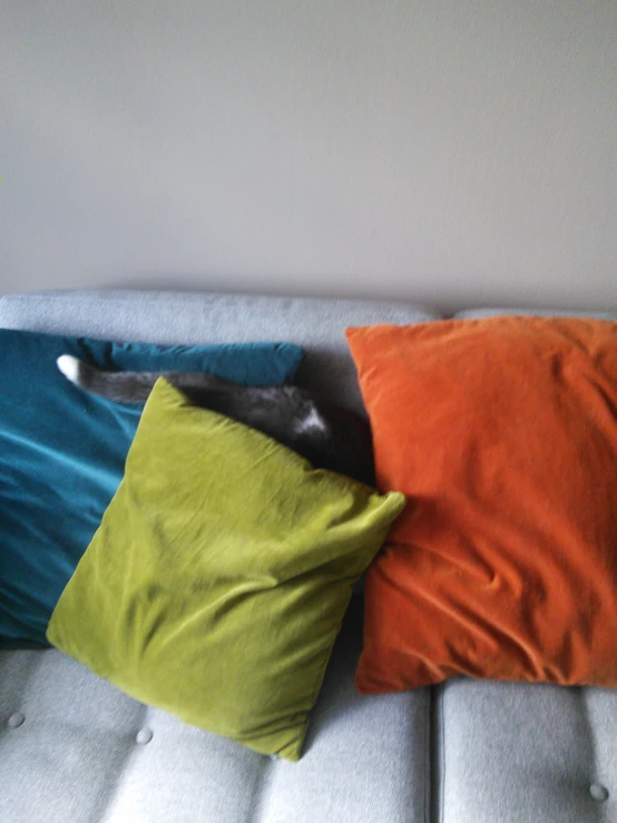 two pillows on top of a couch near each other